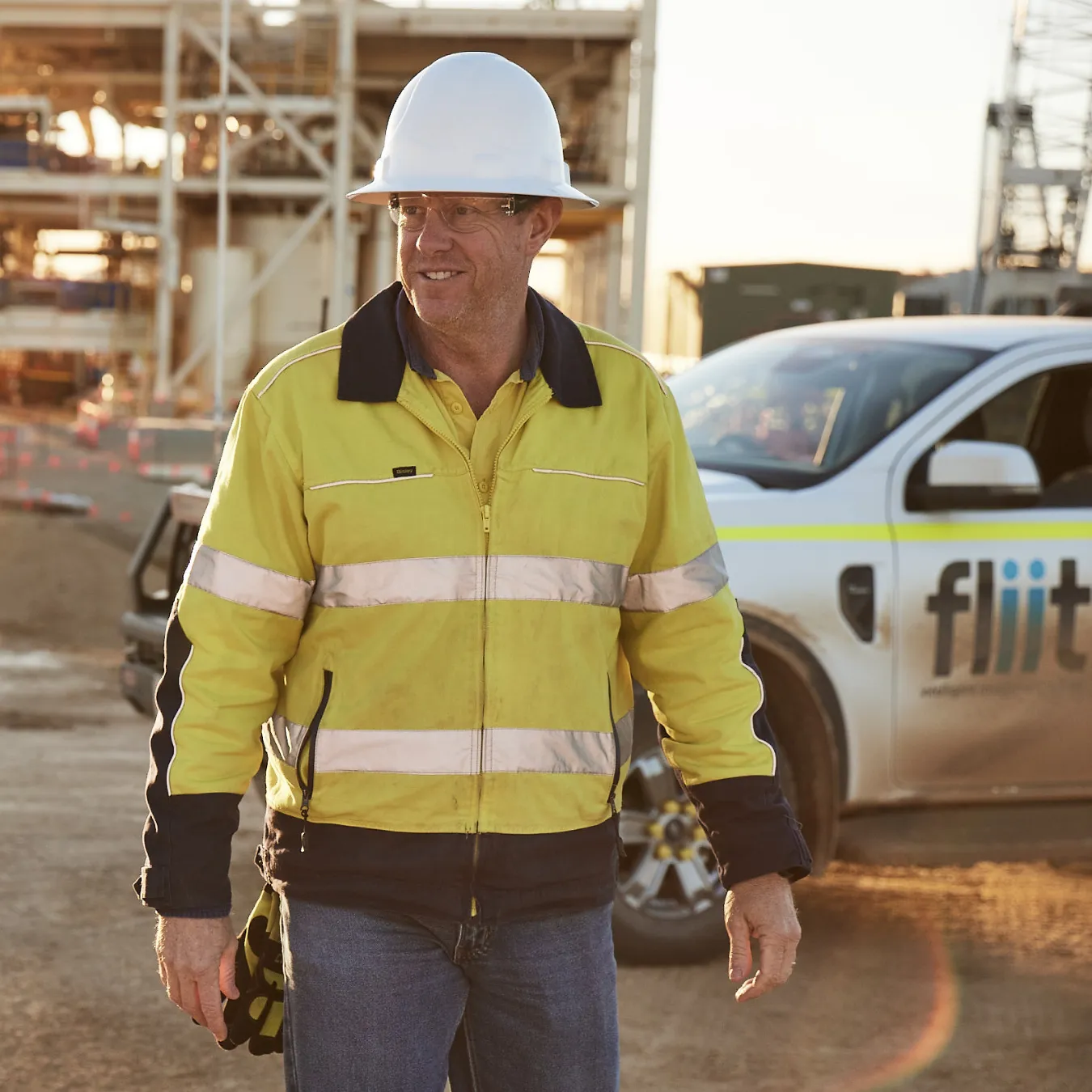 A worker in front of a fliit vehicle