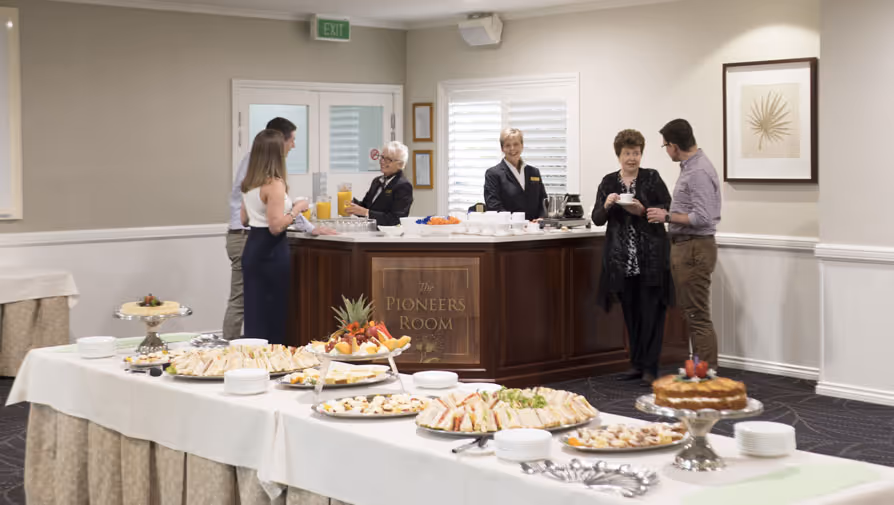 People mingling at a catered reception table.