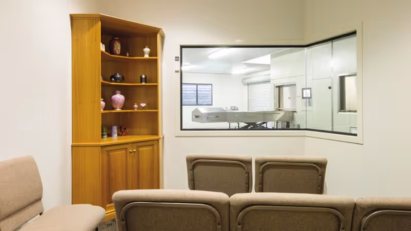 A waiting room with a view of a cremator.