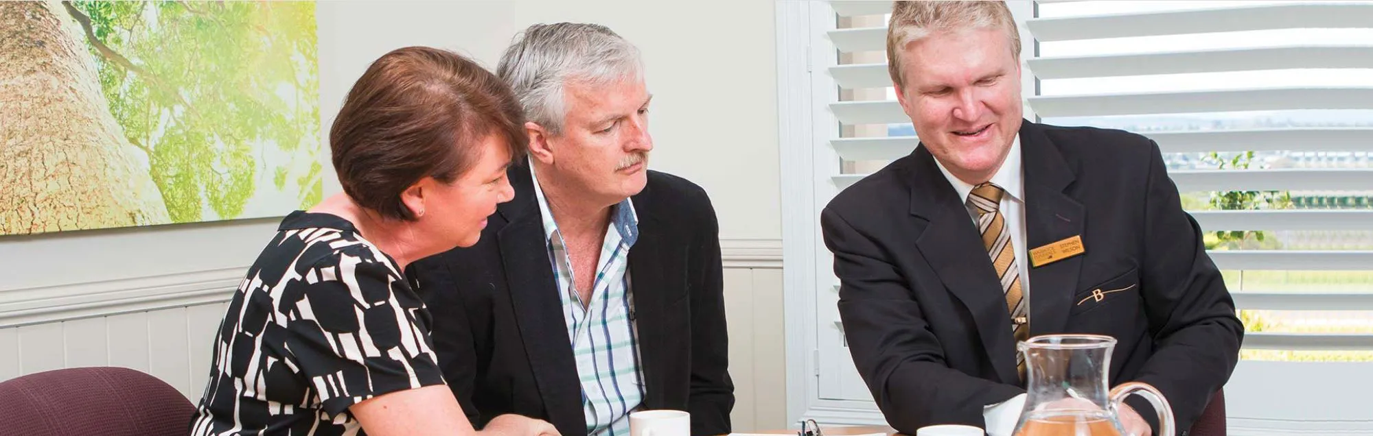 A funeral director consults with a couple about funeral arrangements.