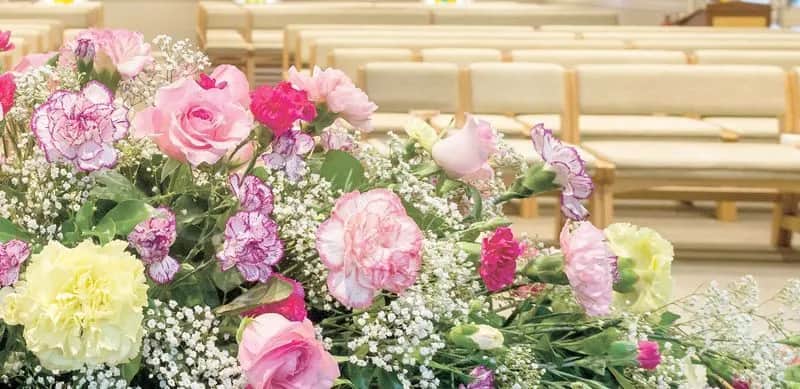 A vibrant floral arrangement in a church.