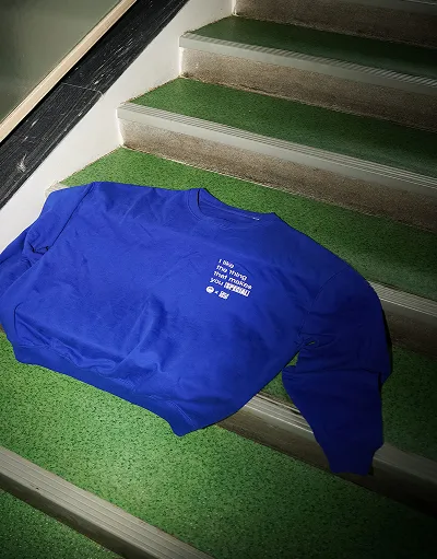 Blue OH-SO sweater photographed on the stairs.