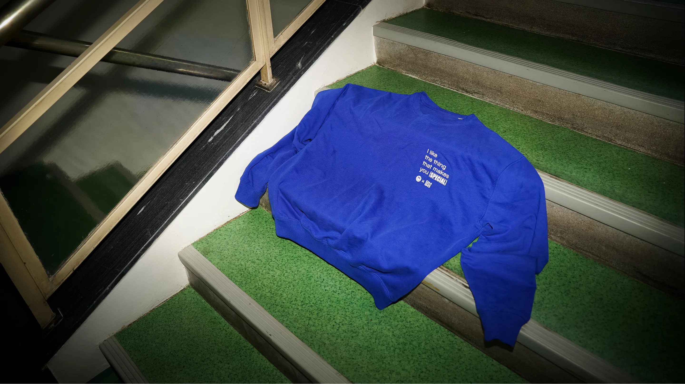 Blue OH-SO sweater photographed on the stairs.