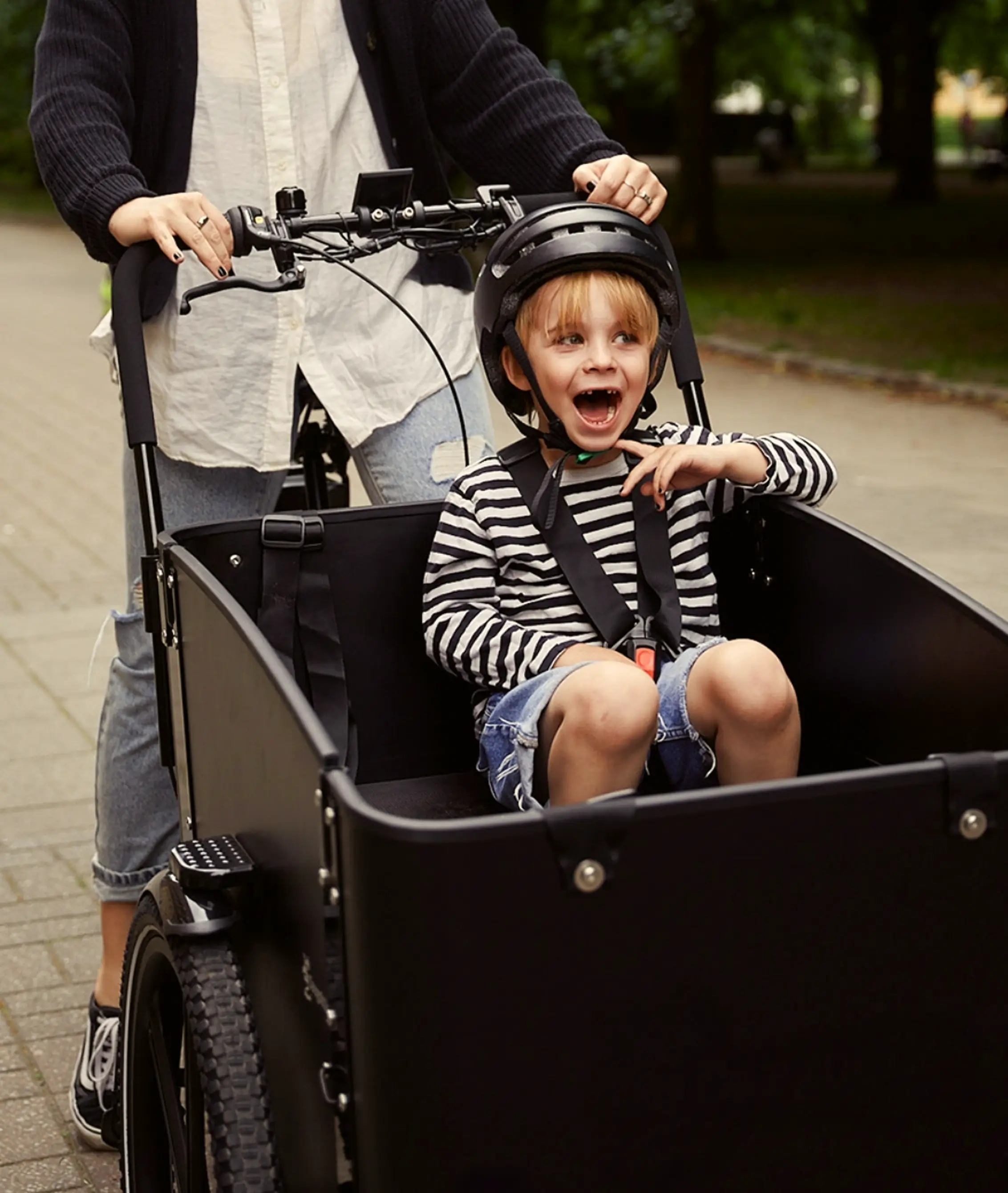 happy kid sitting in cargobike box