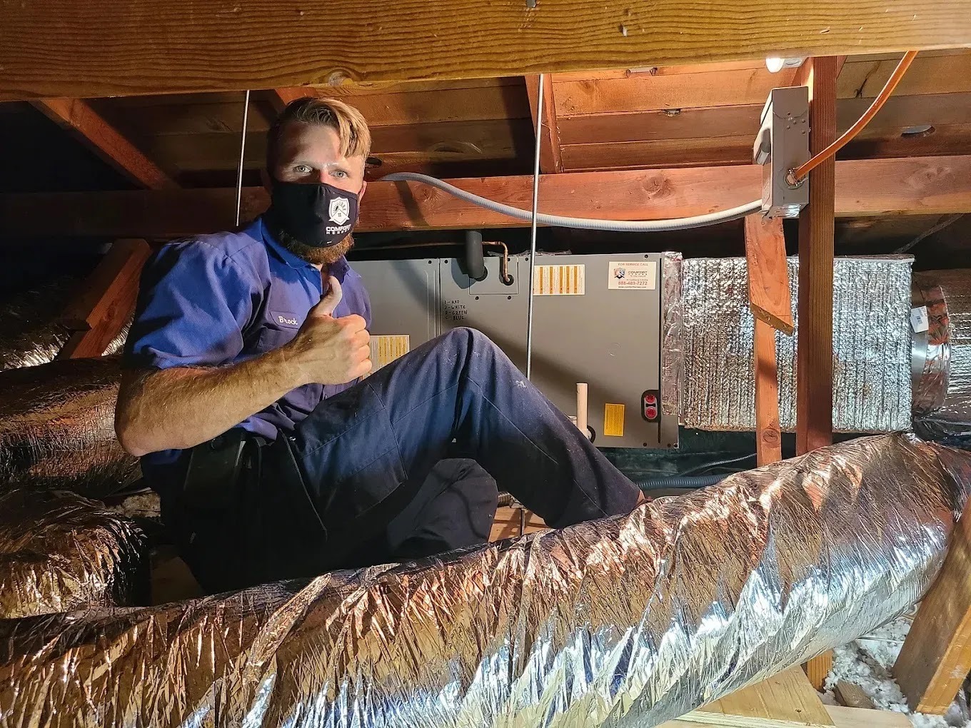 Technician performing spring AC maintenance outdoors, emphasizing summer preparation