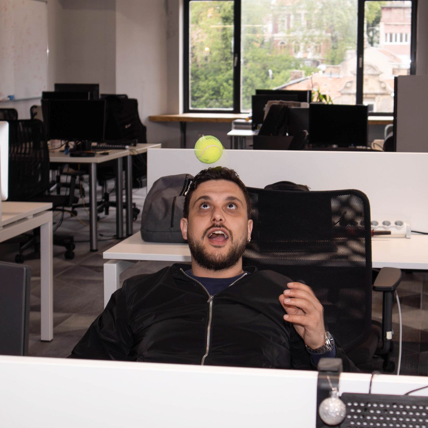 Colleague casually playing with a tennis ball in the office