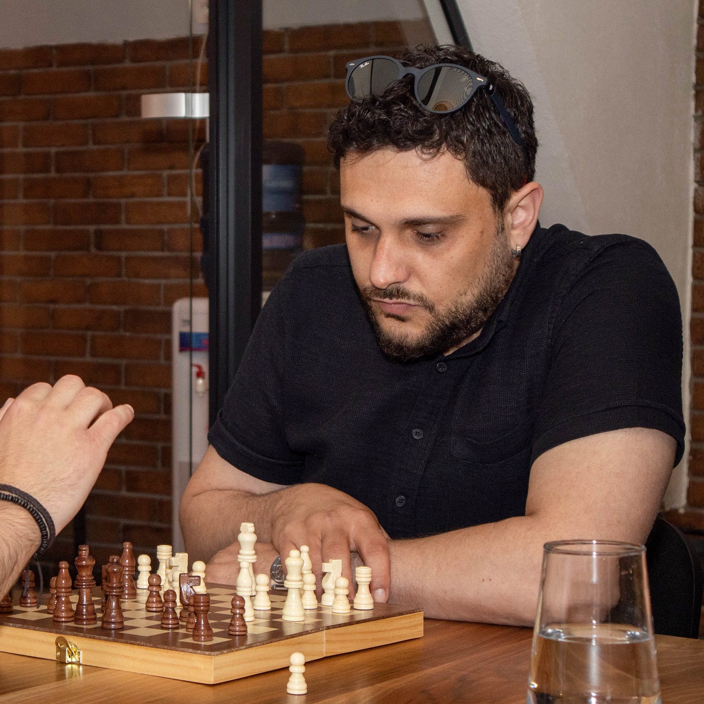 Colleagues playing a game of chess during a break in the office