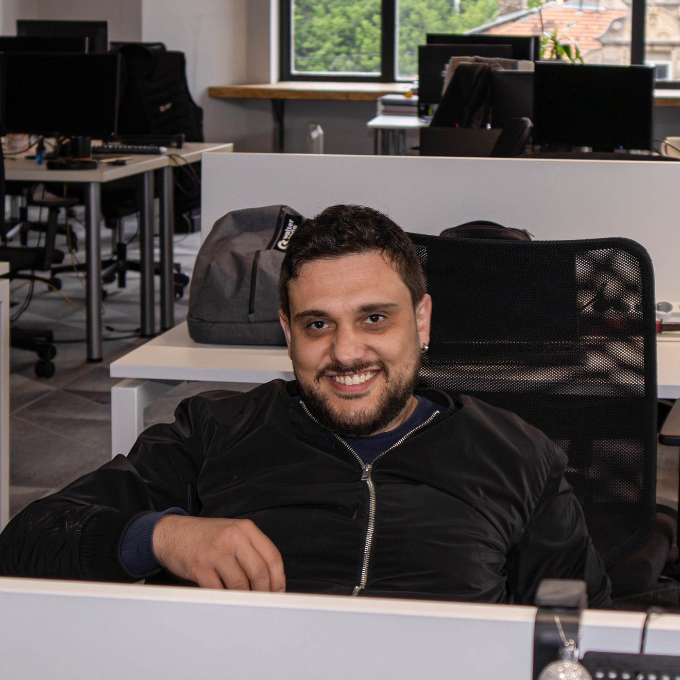 Team member captured smiling at the camera during work