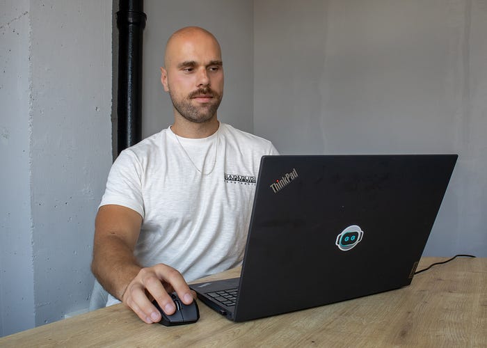 Colleague focused on work at a laptop in a modern office