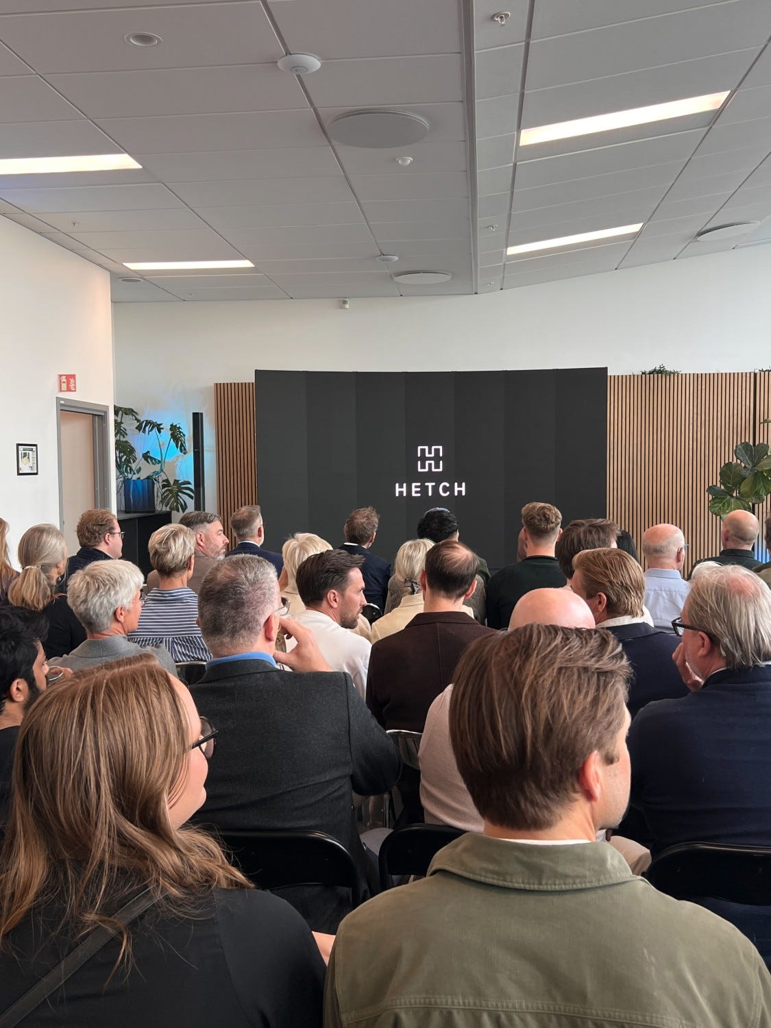 Colleagues attentively watching a presentation in a meeting room