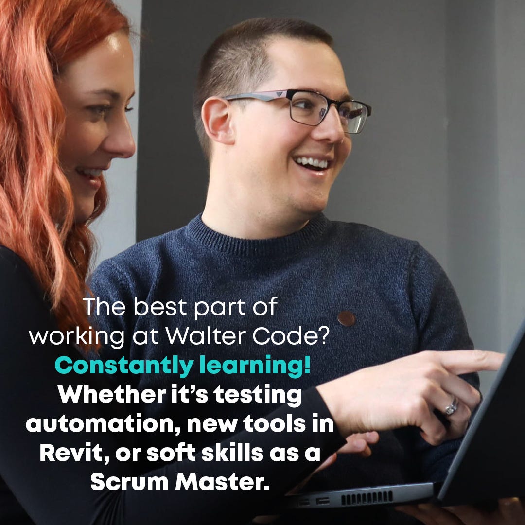 Two colleagues collaborating on a project in the office and smiling