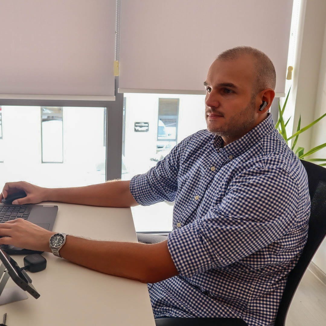 Man focused on working at his laptop in a modern office