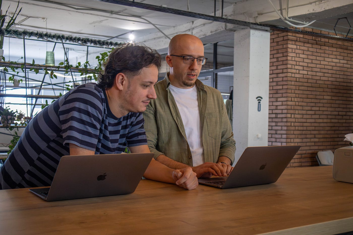 Employees working together on a laptop during a project