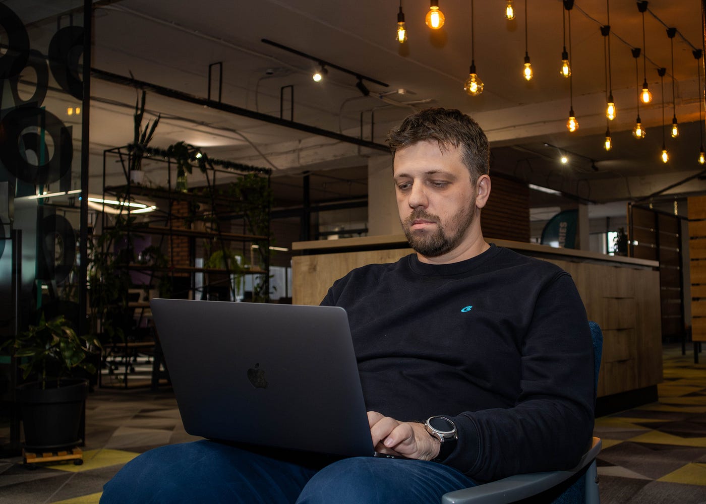 Man working on a laptop in a modern office environment