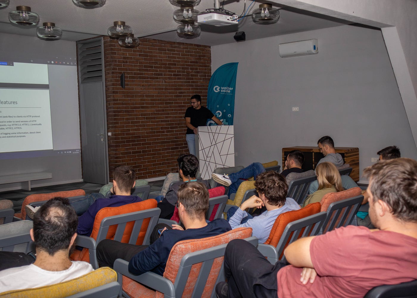 Man giving a workshop presentation while colleagues listen attentively