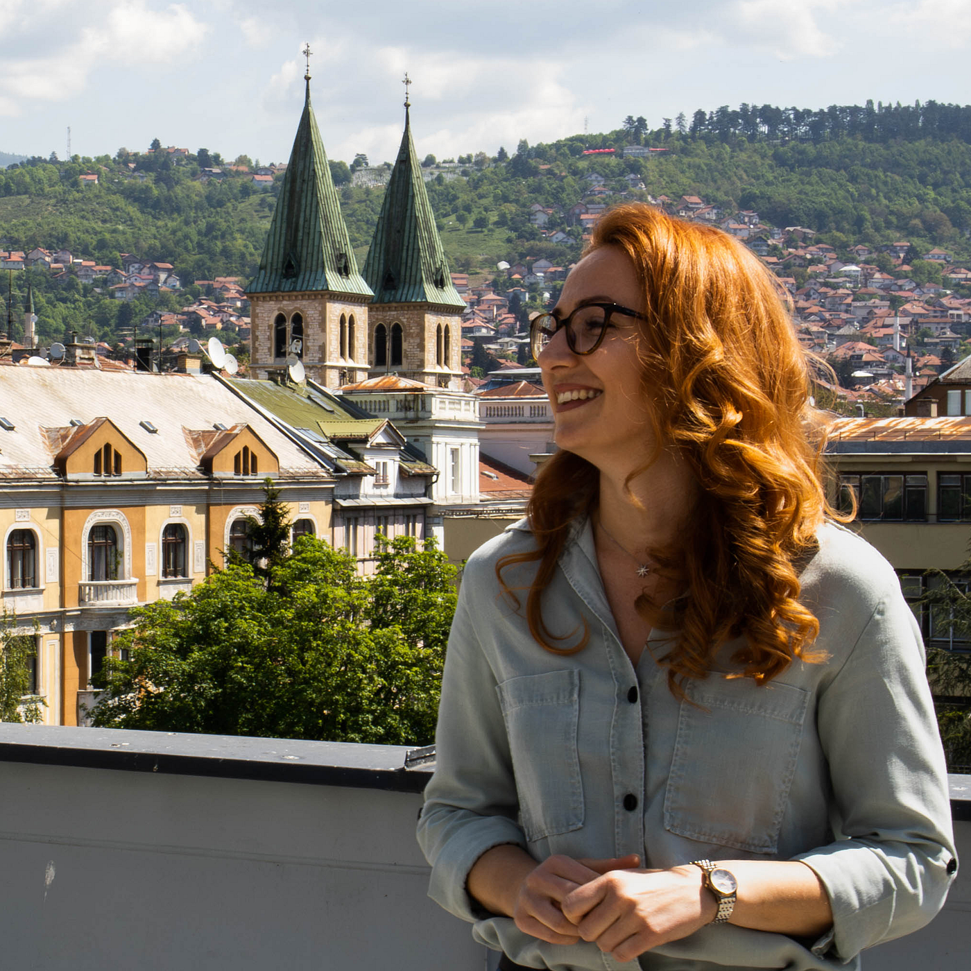 Woman smiling while enjoying a break on the office terrace