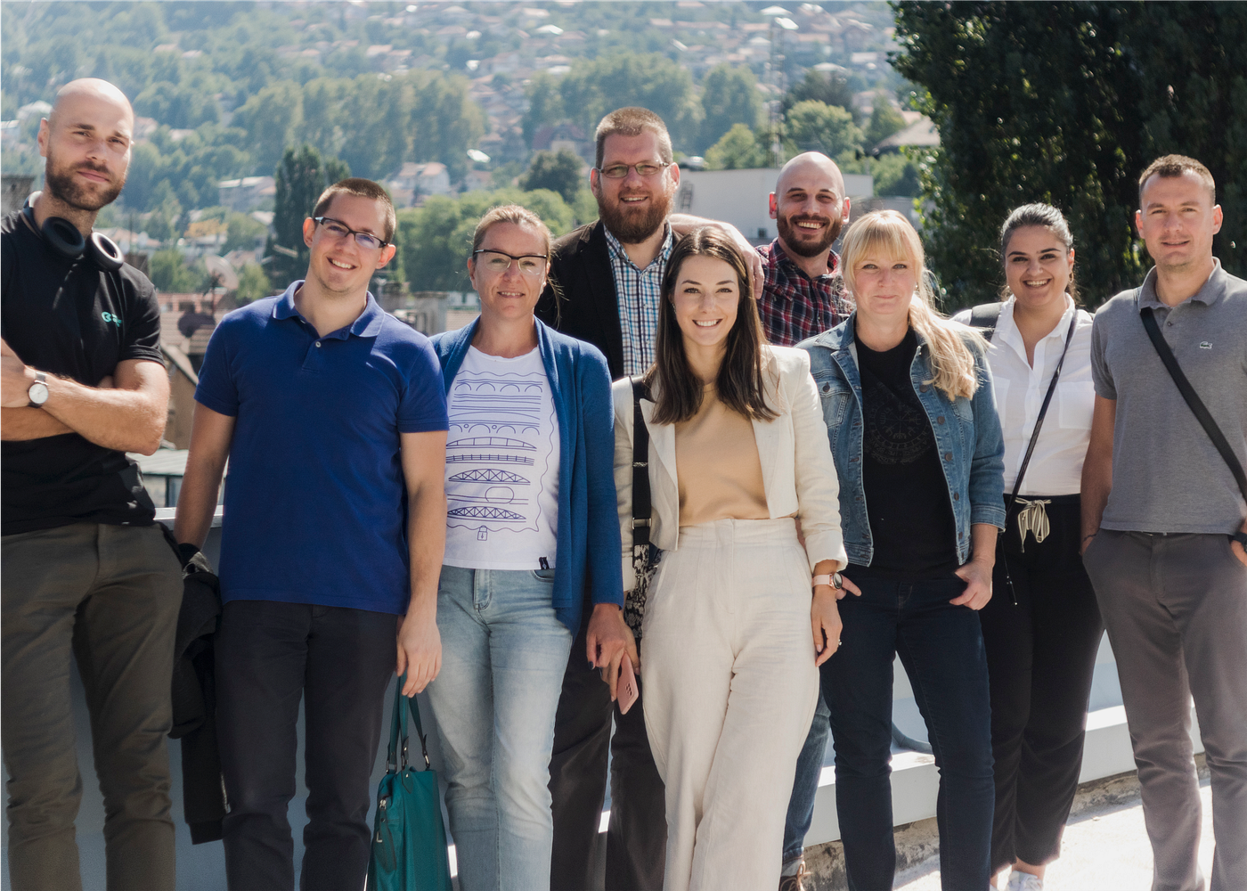 Colleagues posing together on a terrace during a break