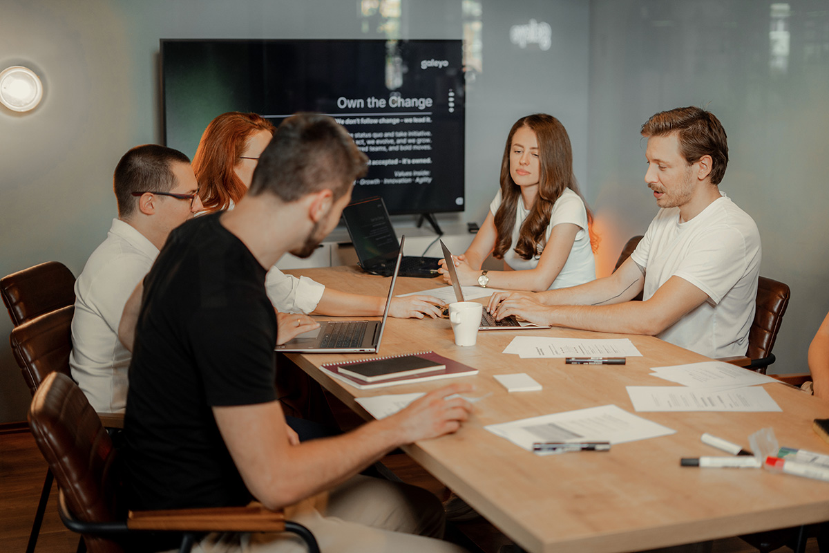 Colleagues brainstorming ideas around a desk in the office