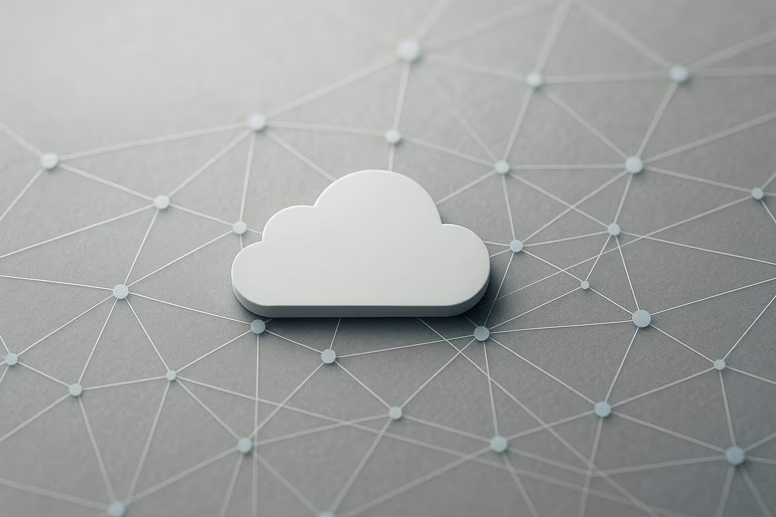 A white cloud shape rests on a gray surface with a network of interconnected dots and lines.