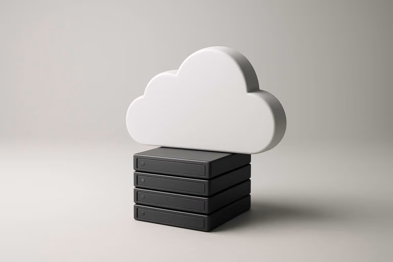 A white cloud-shaped object sits on top of a stack of four black rectangular boxes.