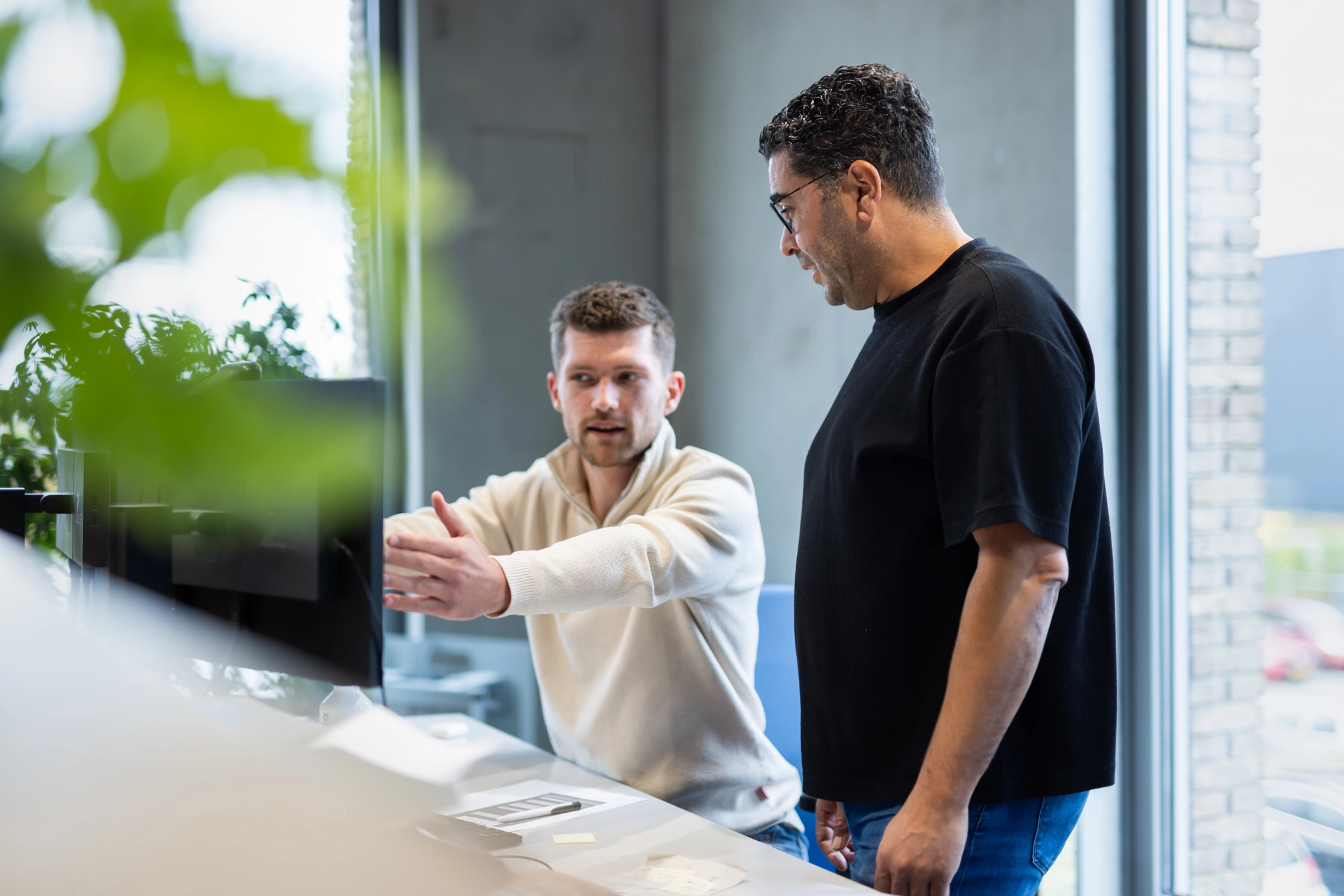 Two Merford colleagues discussing a project at the office.