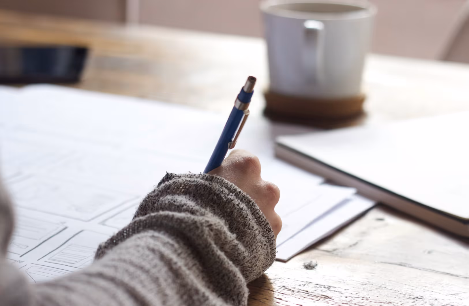 person in the process of creating a user persona template on paper