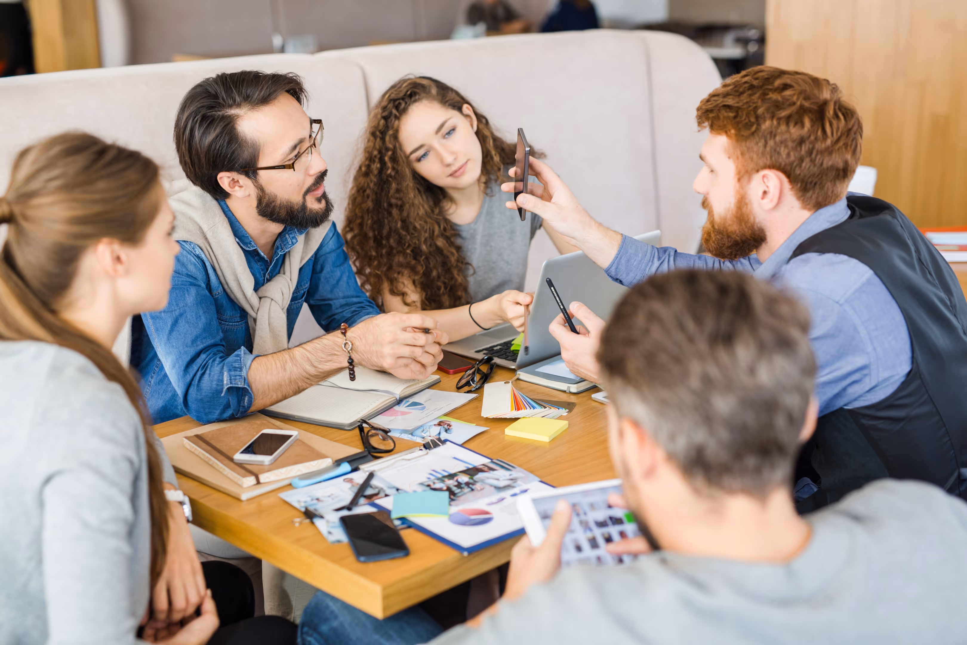UCD process in action, Team collaborating on user centric design strategies in a modern workspace.