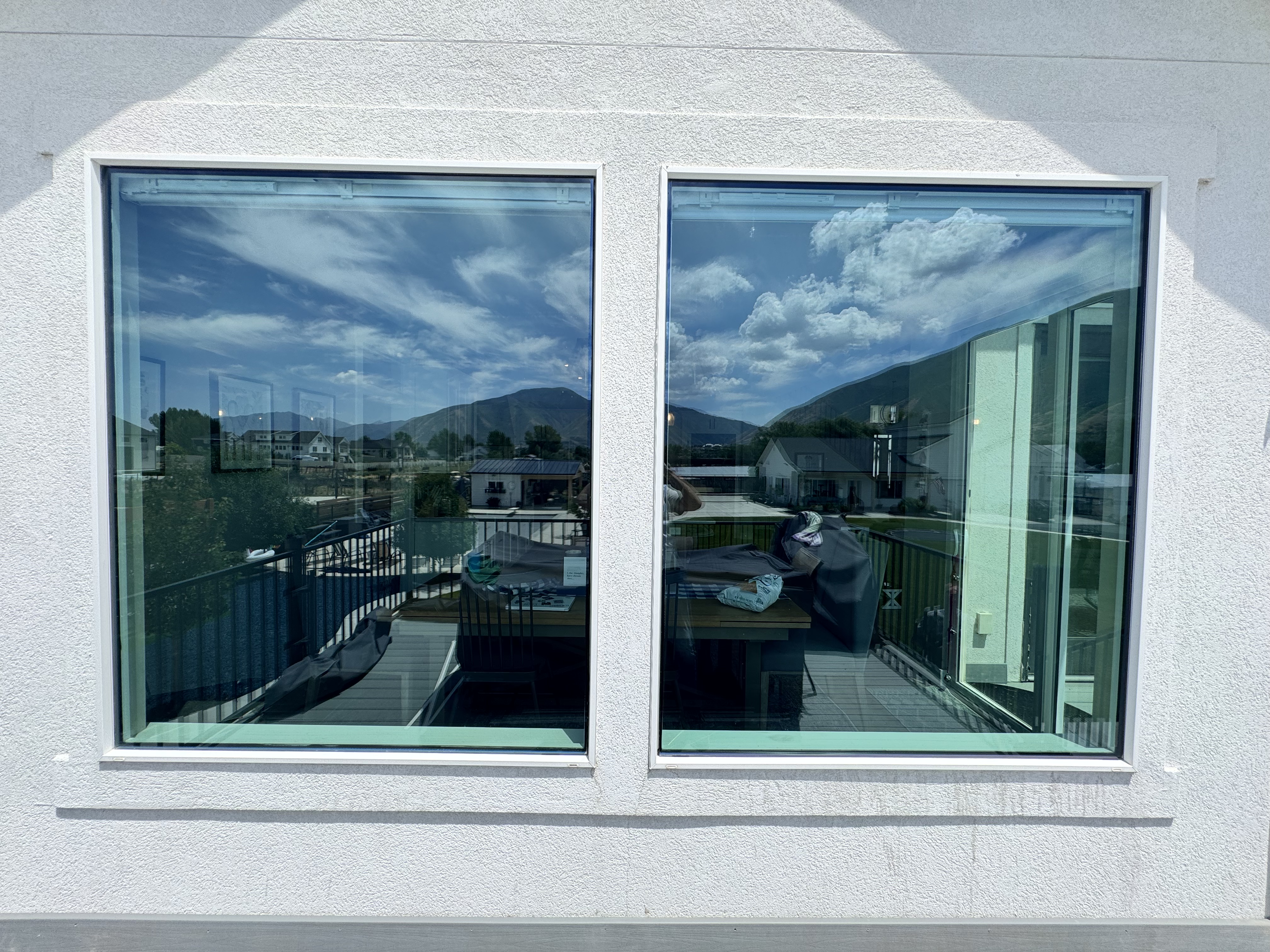 Interior view of two large home windows in Mapleton Utah after exterior window film installation to reduce reflected heat and help prevent turf burn