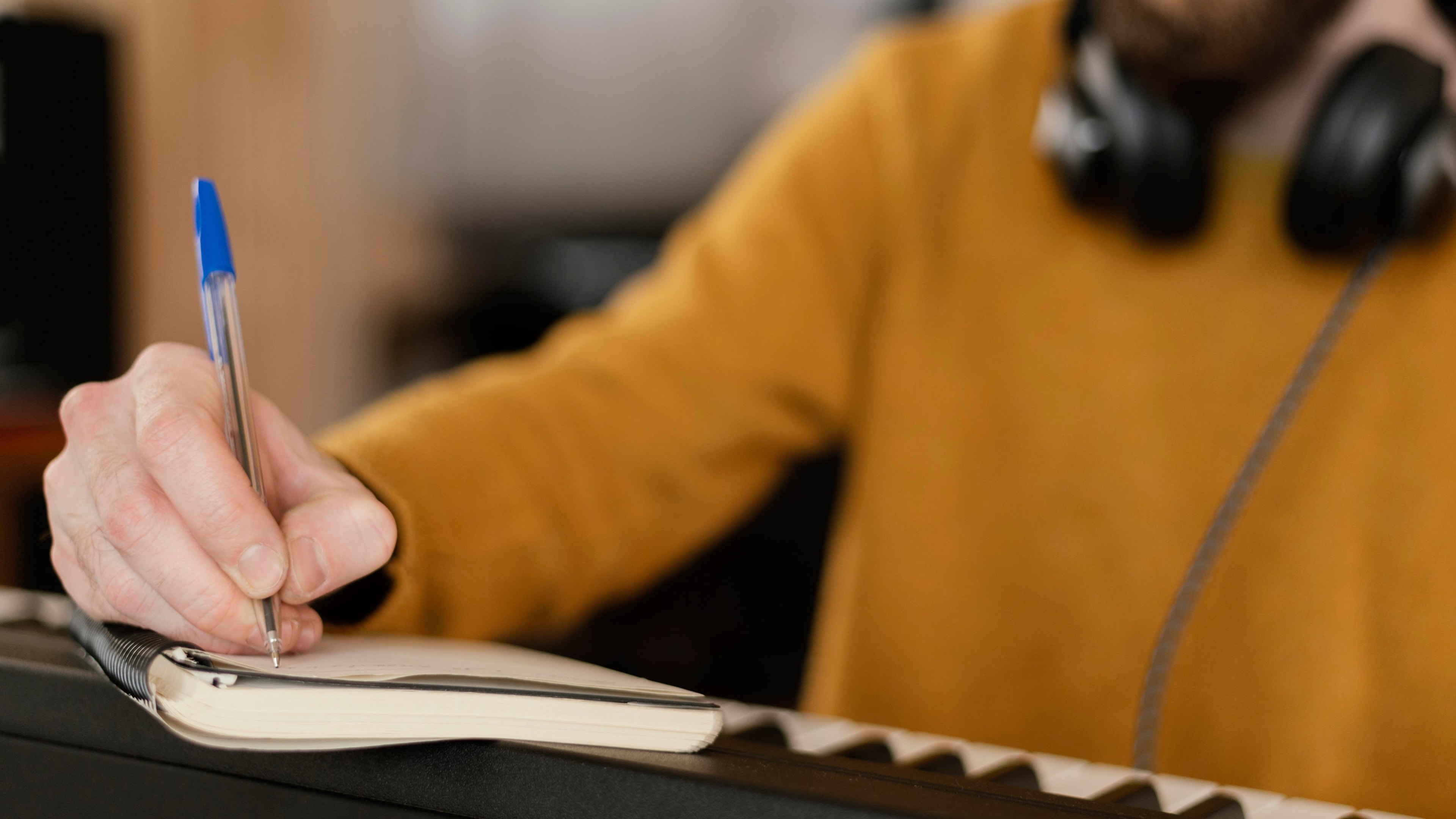 woman writing on pad in studio