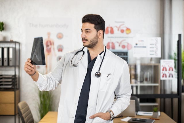 Doctor examining an X-ray image in a medical office setting