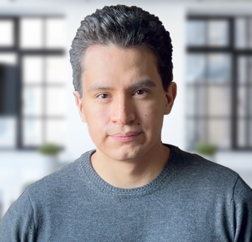 A closeup picture of John Orman looking into the camera with a board room in the background