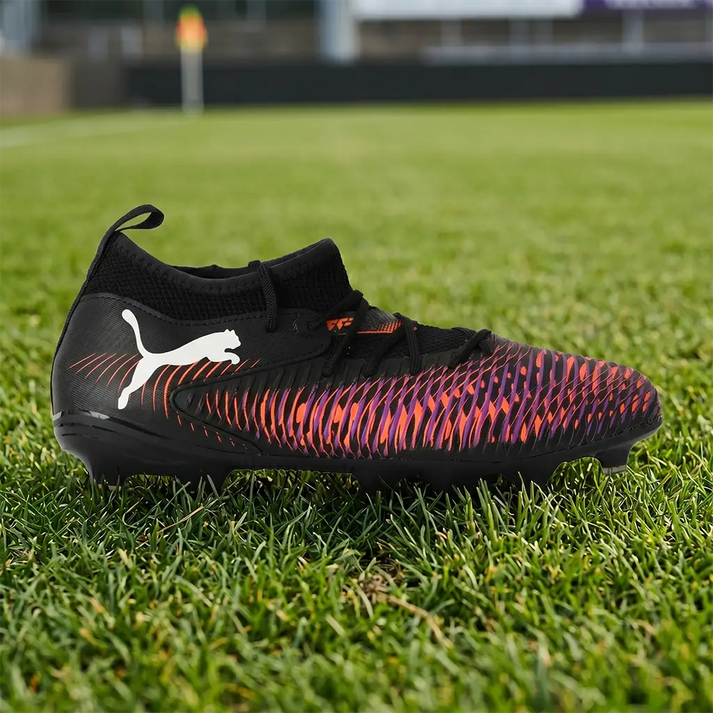 Puma Future 8 Match FG/AG Junior football boots. Black and pink kids' football shoe shown in a detailed profile view on a grass surface. Multi-surface performance featured on the Junior Striker Top 10 list