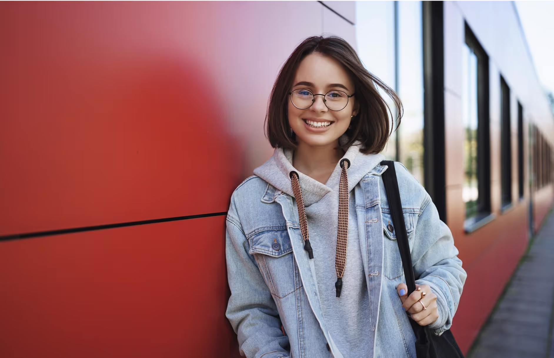 A girl holding her backpack