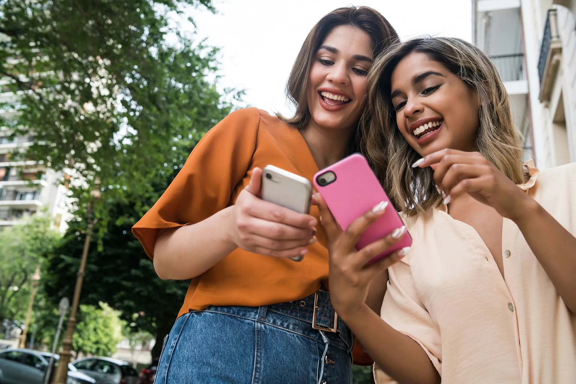 Two women swiping on their phones