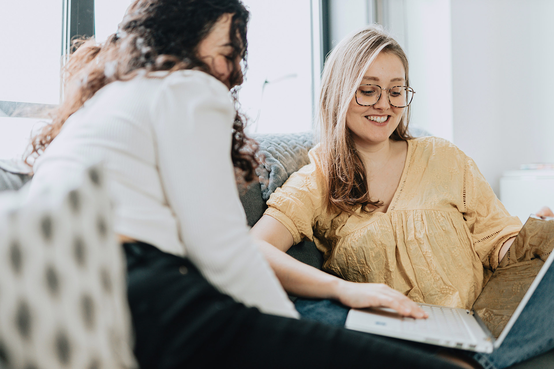 Two women talking with laptop