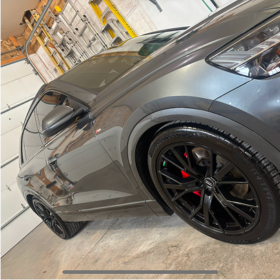 "Side view of a vehicle post-ceramic coating, showing deep gloss and reflection clarity"