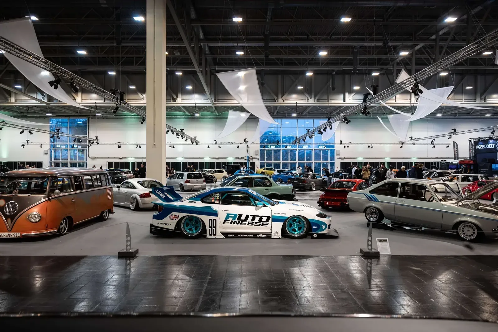 Modified cars on display inside the Essen Motor Show exhibition hall