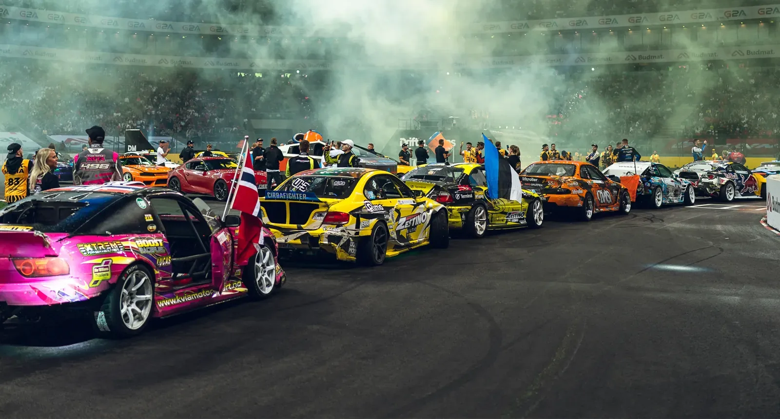 Drift Masters cars and drivers lined up in a stadium