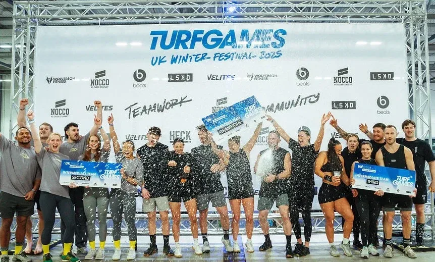 Teams celebrating on the podium at the Turf Games UK Winter Festival