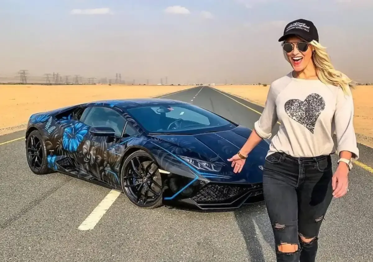 Supercar Blondie beside a custom-wrapped supercar on a desert road
