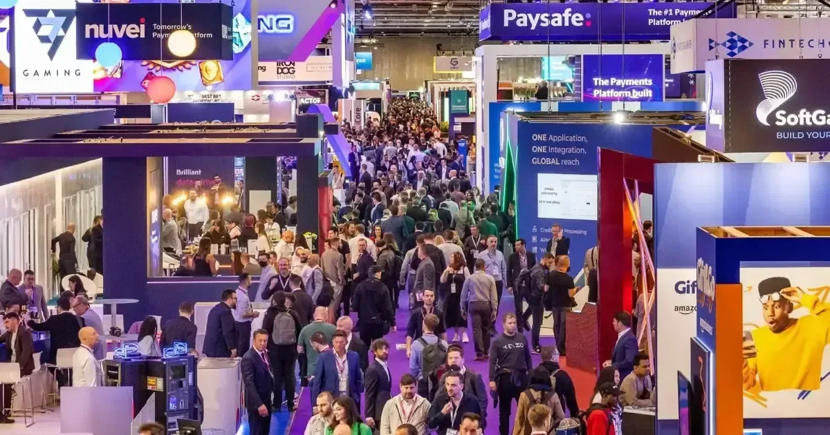 Visitors exploring gaming and payment technology stands at ICE