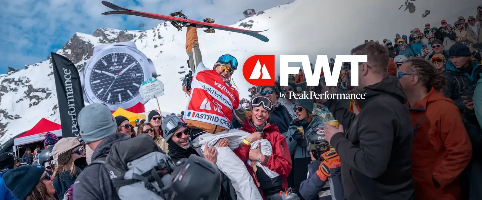 A skier celebrating with the crowd at the Freeride World Tour