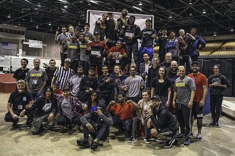 Parkour athletes gathered together at an indoor competition venue
