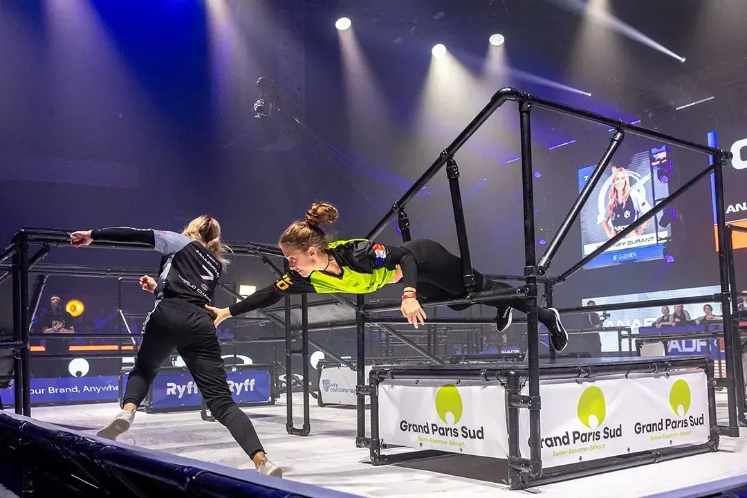 Two athletes competing on the World Chase Tag obstacle course