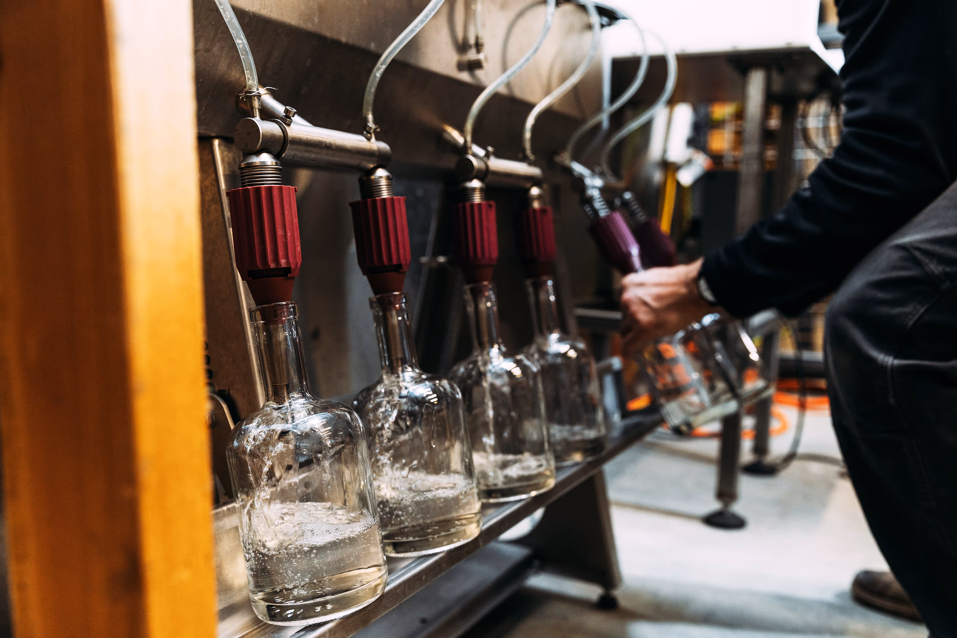 hands filling containers with alcohol