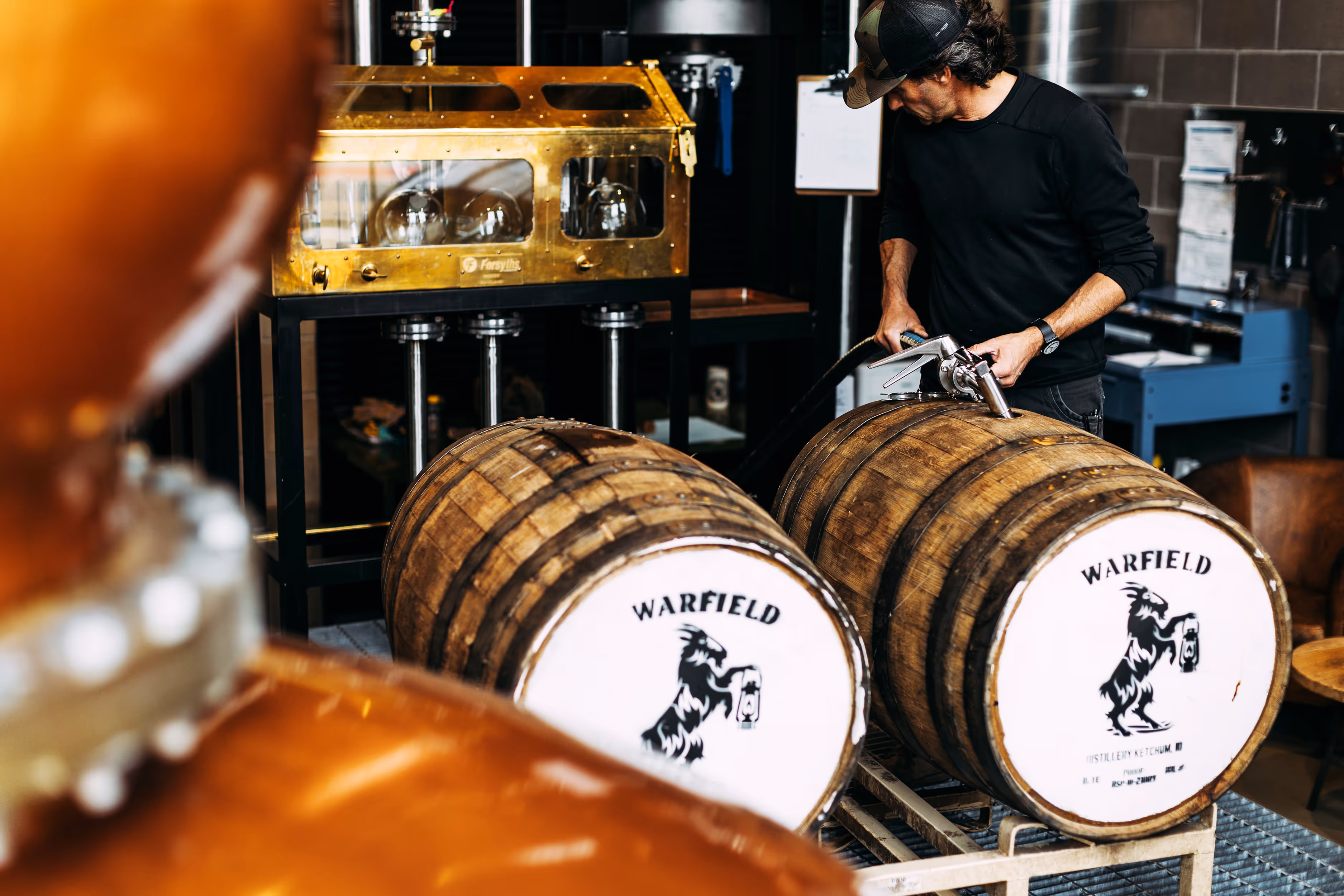 man filling barrels with alcohol