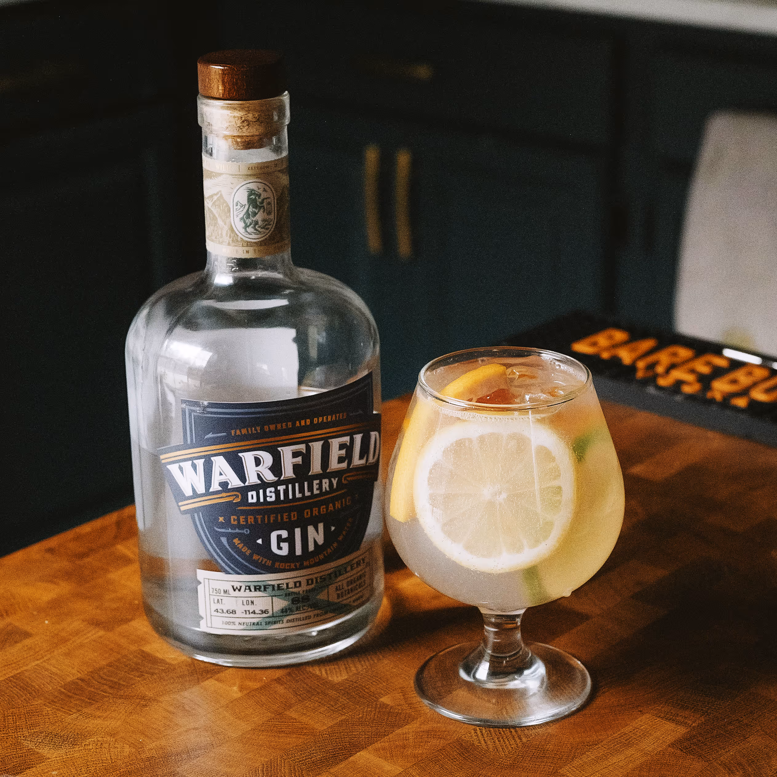 Gin bottle next to cocktail
