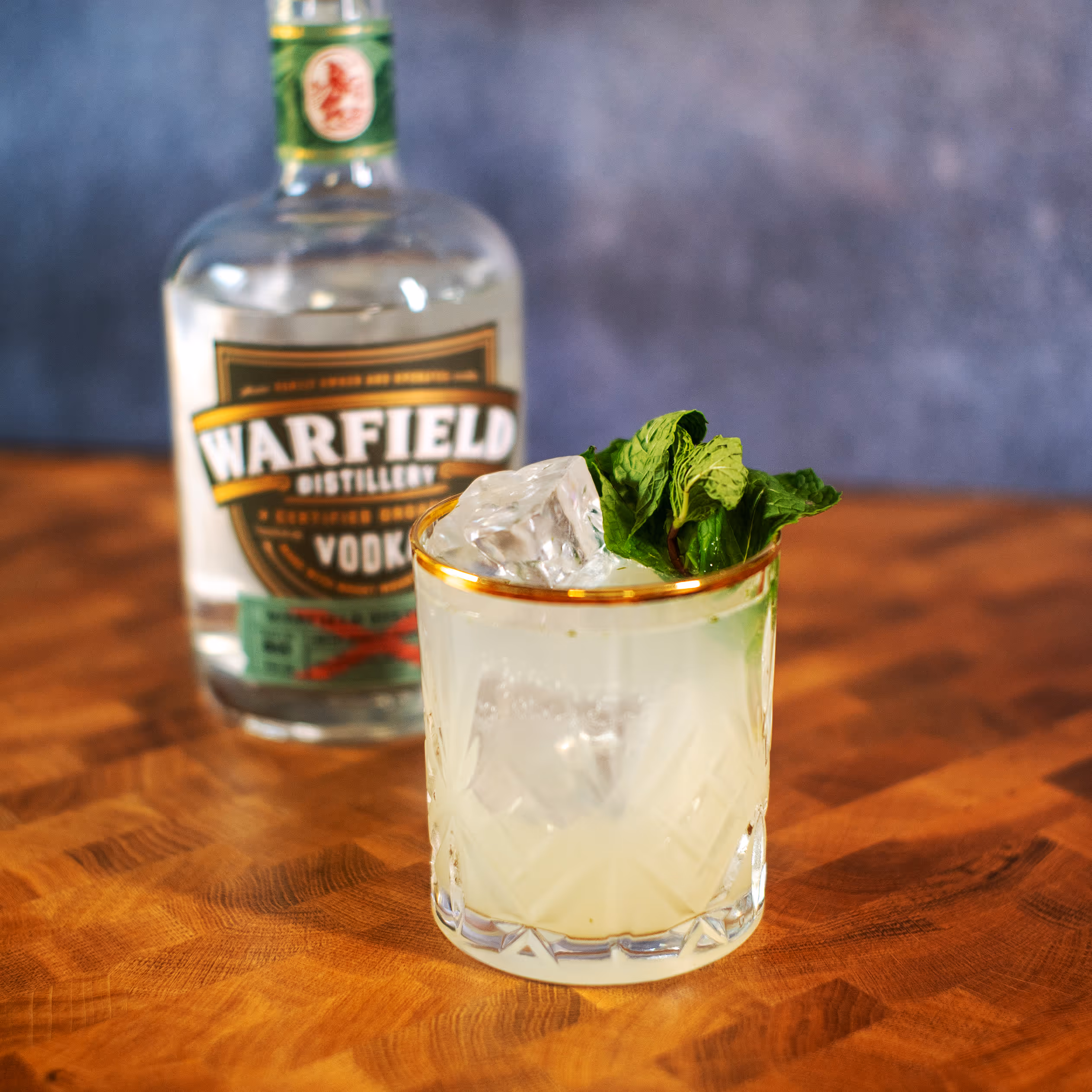 Vodka bottle behind cocktail