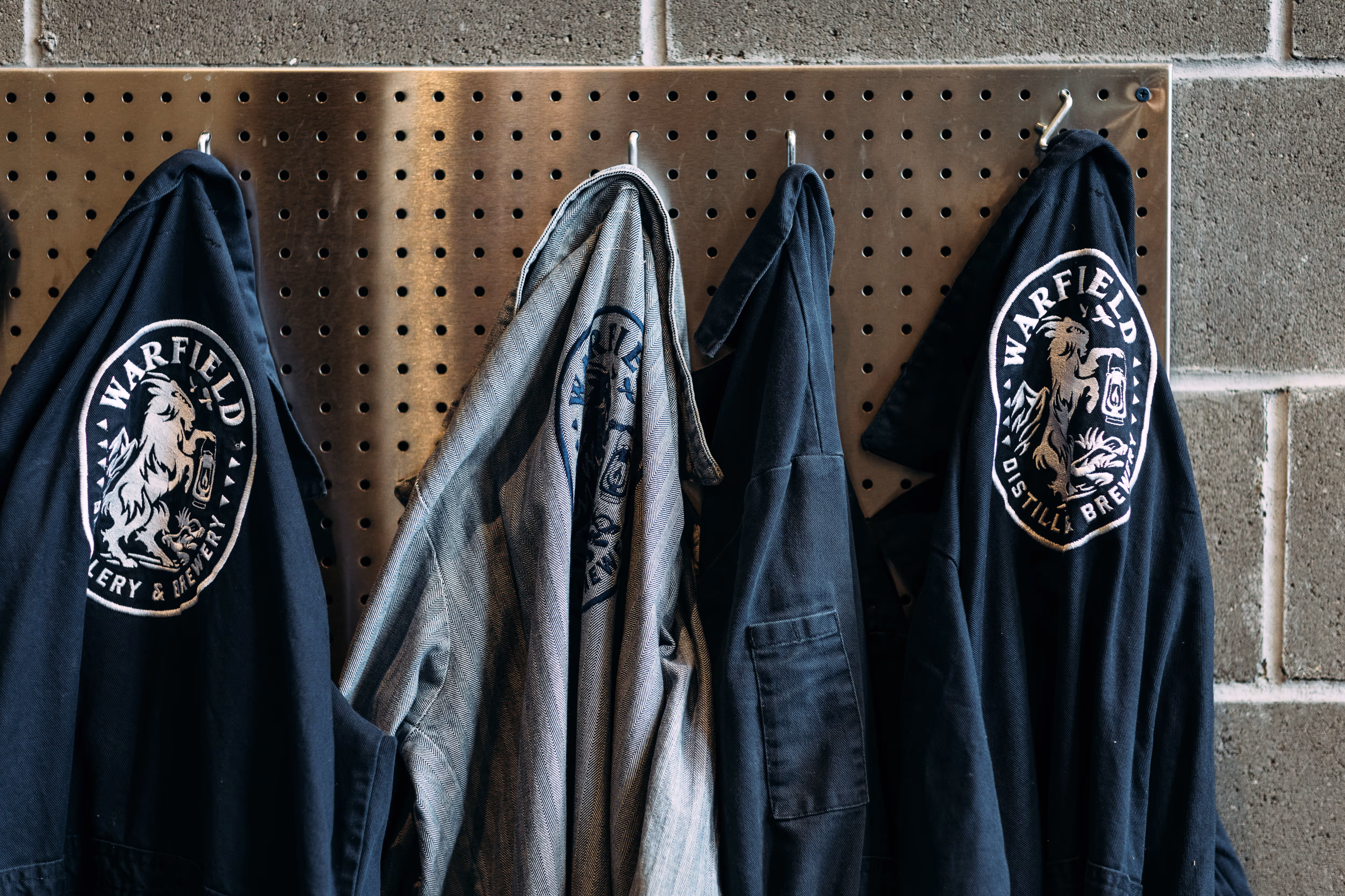 work jackets hanging from a pegboard