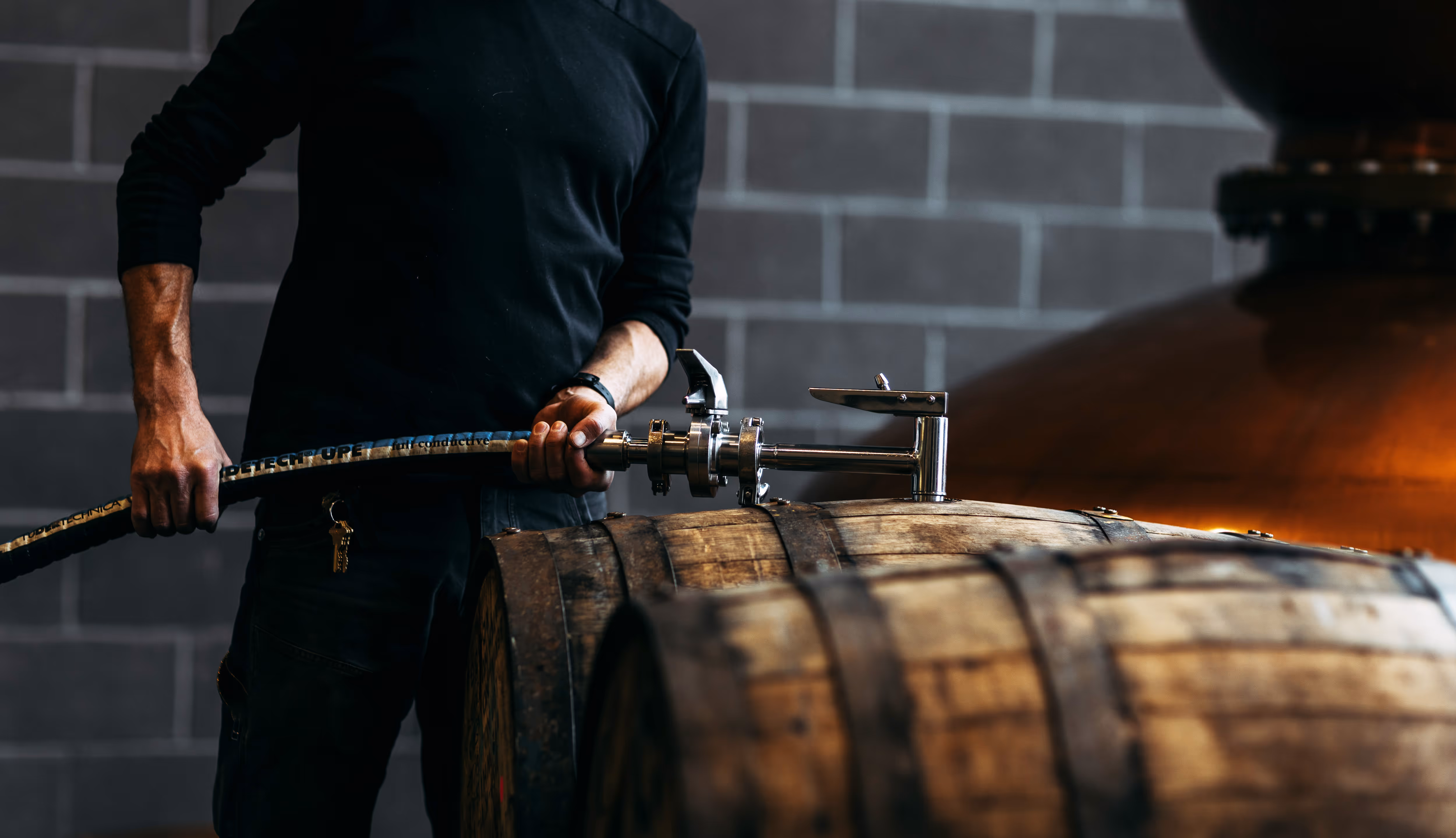 Hands filling beer glass from tap